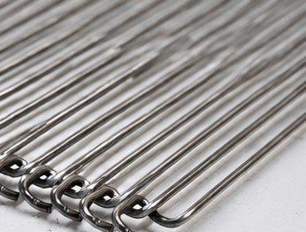 Close-up of stainless steel conveyor belt rods with looped ends